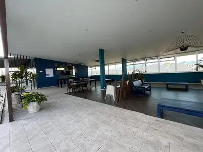 a lobby of a building with tables and chairs at Bambu-Rivera Club Residences in San José