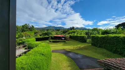 a view of a garden with a gazebo at Coffee Garden Ranch Costa Rica in Concepción