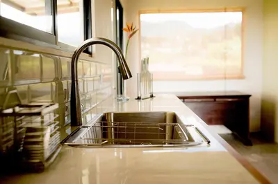 a kitchen counter with a sink and a window at Coffee Garden Ranch Costa Rica in Concepción