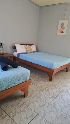 two beds sitting in a room with at Georgi, Junquillal in Playa Junquillal