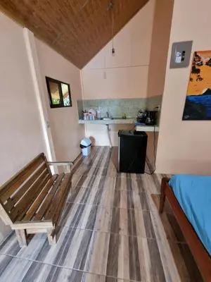 a room with a bench and a table in it at Ballena Oasis Homes & Glamping in Uvita