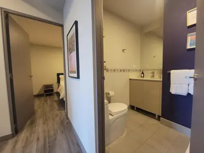 a bathroom with a toilet and a sink at Cosmopolitan APT 1407, 5 Star Facilities, 15m SJO Airport, Parking, Pool, Gym in San José