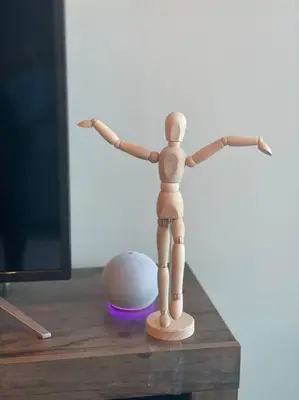 a small wooden mannequin standing on a table at Cosmopolitan APT 1407, 5 Star Facilities, 15m SJO Airport, Parking, Pool, Gym in San José