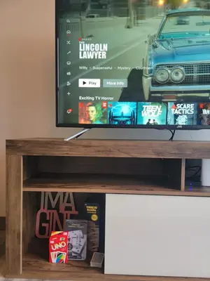 a flat screen tv sitting on top of a wooden shelf at Cosmopolitan APT 1407, 5 Star Facilities, 15m SJO Airport, Parking, Pool, Gym in San José