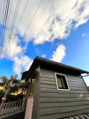 a house with a balcony and a blue sky at Pizote house in Monteverde Costa Rica
