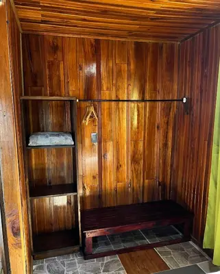 a wooden sauna with a bench in a room at Pizote house in Monteverde Costa Rica