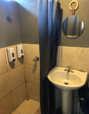 a bathroom with a sink and a shower with a mirror at Pizote house in Monteverde Costa Rica
