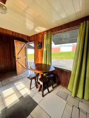 a room with a table and chairs and a window at Pizote house in Monteverde Costa Rica