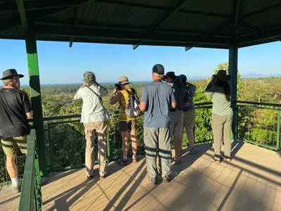a group of people standing on top of a viewing deck at Tarcoles Birding Lodge in Tarcoles