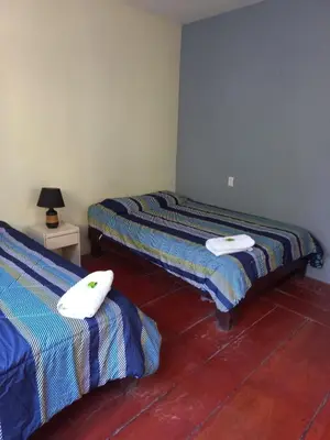 a room with two beds with towels on them at Donde Familia Manito in Paquera