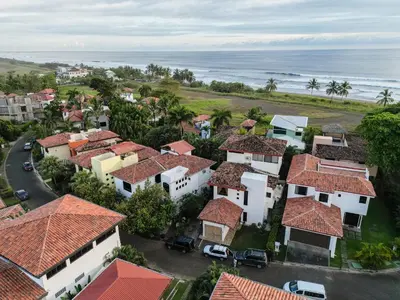 an aerial view of a town with houses and the ocean at Casa Lapa Penthouse Oceanside Villa in Playa Hermosa