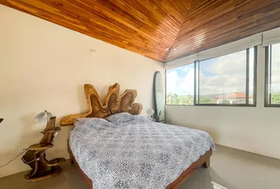 a bedroom with a large bed with a wooden ceiling at Casa Lapa Penthouse Oceanside Villa in Playa Hermosa