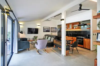 a living room with a couch and a table at Villa Taleona in Santa Teresa Beach
