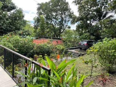 a car parked in a garden next to a fence at Villa Venus in Santa Teresa Beach