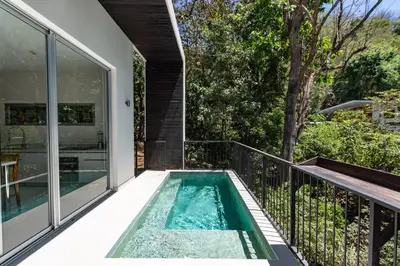 a swimming pool on the balcony of a house at Villa Venus in Santa Teresa Beach