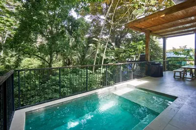 a swimming pool on the deck of a house at Villa Venus in Santa Teresa Beach