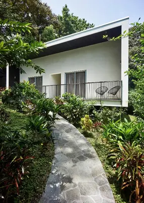 a walkway leading to a house with a balcony at Villa Venus in Santa Teresa Beach