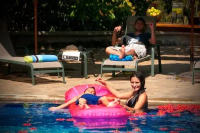 a woman and a baby swimming in a pool at Unique Architecture, 3 Pools and Wi-Fi in Orotina
