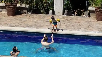 a child is standing in a swimming pool at Private Pool & WiFi in Puntarenas