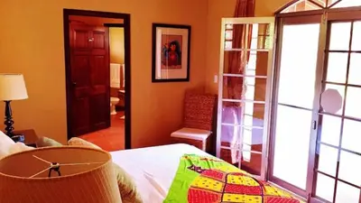 a bedroom with a bed and a living room at Private Pool & WiFi in Puntarenas