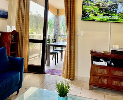 a living room with a couch and a table at BEACHFRONT Condo Bahia Encantada L1 Jaco Beach in Jacó