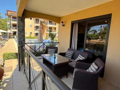 a balcony with chairs and a table on a balcony at BEACHFRONT Condo Bahia Encantada L1 Jaco Beach in Jacó