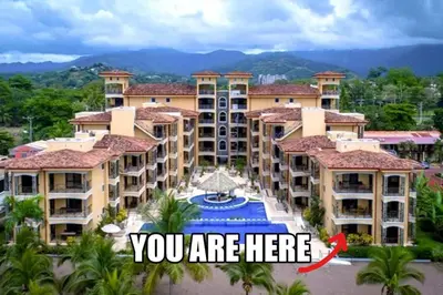 a building with a sign that says you are here at BEACHFRONT Condo Bahia Encantada L1 Jaco Beach in Jacó