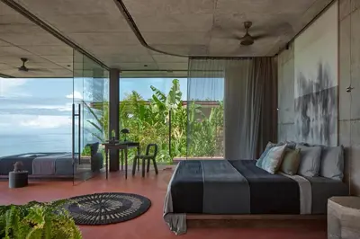 a bedroom with a bed and a view of the ocean at ACHIOTÉ Architectural Gem - Adults Only in Uvita