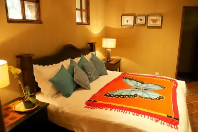 a bedroom with a bed with a colorful blanket on it at 4 Architectural homes, Pool and High-Speed Internet in Lagunillas