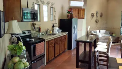 a kitchen with a refrigerator and a table in it at 4 Architectural homes, Pool and High-Speed Internet in Lagunillas