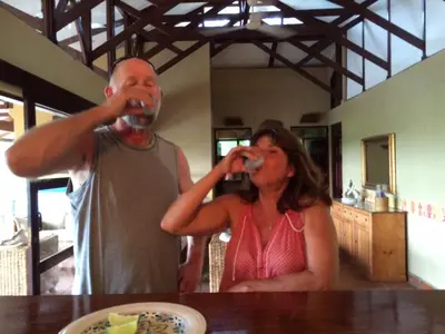 a man and a woman drinking wine at a table at 4 Architectural homes, Pool and High-Speed Internet in Lagunillas