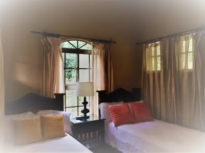 a bedroom with two beds and a window at 4 Architectural homes, Pool and High-Speed Internet in Lagunillas