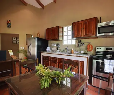 a kitchen with a table with a bowl of fruit on it at 4 Architectural homes, Pool and High-Speed Internet in Lagunillas