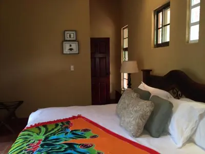 a bedroom with a bed with a colorful blanket on it at Unique 5 Architectural Homes, Pool & Wi-Fi in Lagunillas