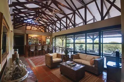 a large living room with couches and a bar at Unique 5 Architectural Homes, Pool & Wi-Fi in Lagunillas