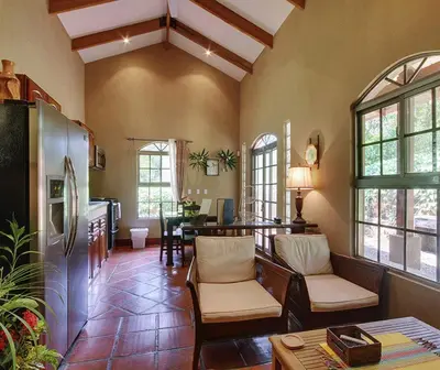 a living room with a refrigerator and a table at Unique 5 Architectural Homes, Pool & Wi-Fi in Lagunillas