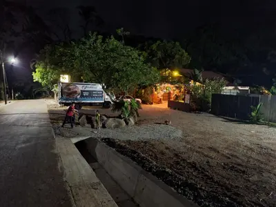 a person walking down a street at night at Guapote Lodge in Tigra