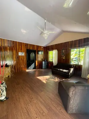a living room with a couch and a ceiling fan at Grand Park Manuel Antonio - Adults Only in Manuel Antonio