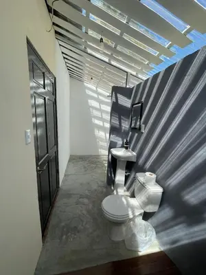 a bathroom with a toilet in a room at Grand Park Manuel Antonio - Adults Only in Manuel Antonio