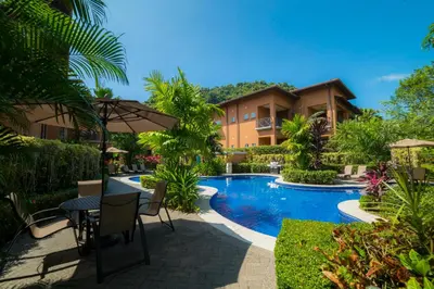 a villa with a swimming pool in a resort at Veranda 6F 2 bdr Garden View in Los Suenos in Herradura