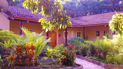 a house with a garden in front of it at 3 Architectural Homes, Wi-fi and Pool in Lagunillas