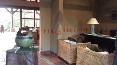 a living room with two chairs and a vase on a table at 3 Architectural Homes, Wi-fi and Pool in Lagunillas