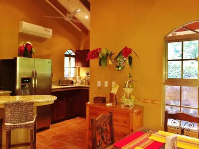 a kitchen with a stainless steel refrigerator and a counter at 3 Architectural Homes, Wi-fi and Pool in Lagunillas