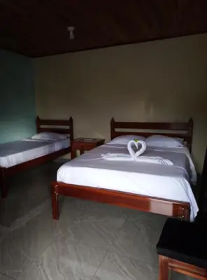 a bedroom with two beds with a heart on it at Cabinas El Pilón Río Celeste in San Rafael