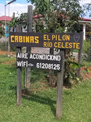 a sign that says cities el palon rico collective at Cabinas El Pilón Río Celeste in San Rafael