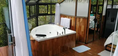 a bathroom with a sink in a room with a window at Cristal House Mountain View in Heredia