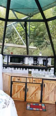 a kitchen in a tent with a counter top at Cristal House Mountain View in Heredia
