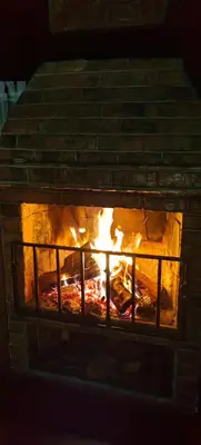 a brick oven with a fire inside of it at Cristal House Mountain View in Heredia