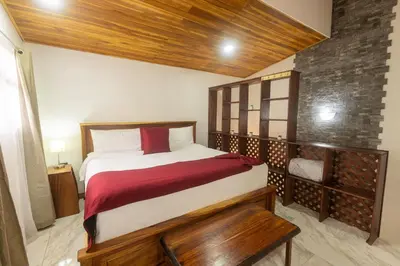 a bedroom with a large bed with a wooden headboard at Casas Clusia in Monteverde Costa Rica