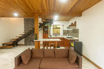 a living room with a couch and a kitchen at Casas Clusia in Monteverde Costa Rica